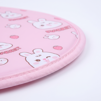 Snaggoo cat cooling gel mat close-up, piped fabric edge and cool-gel surface with rabbit and strawberry print